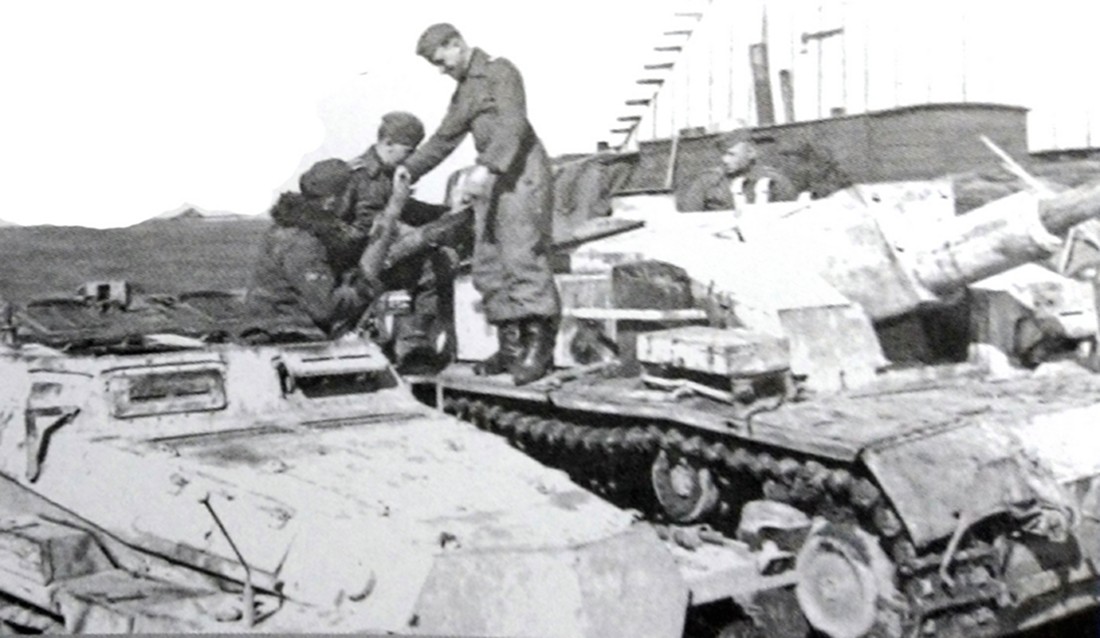 1942年冬季,东线苏联战场,德军一辆Sd.Kfz.252半履带装甲弹药运载车正在为一辆德军Ⅲ号突击炮车输送弹药。