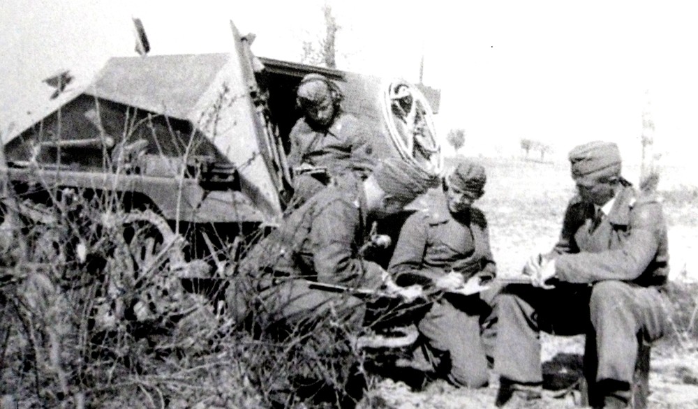 1941年,德军入侵巴尔干,在希腊战场,一辆253型半履带装甲炮兵观测车内的德军Ⅲ号突击炮部队指挥官在车外正在开会商研战场态势。