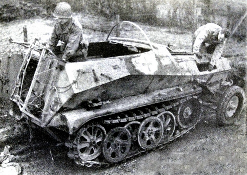 1944年12月，西线德国战场，一辆被德军第9装甲师遗弃的Sd.Kfz.250/2半履带装甲野战电话布线车，两名美军正在对该车进行检查。