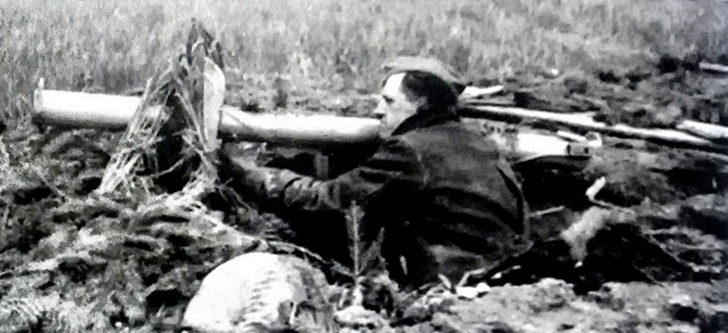1944年10月,德国战场,一名在田野中作了伪装的德国「人民冲锋队」的成员士兵拿着「坦克杀手」反坦克火箭筒正在等待苏军坦克的进攻。