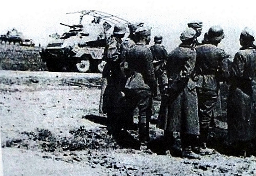 1941年7月,东线战场,正向苏联深纵挺进的德军第8装甲师一群官兵正在一辆Sd.Kfz.232轮式(8轮)装甲通讯车旁边研究战场态势。