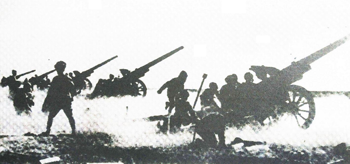 1942年2月，中国抗日战场，日军的一处野战炮阵地上，多门105毫米加农炮正在开炮射击。