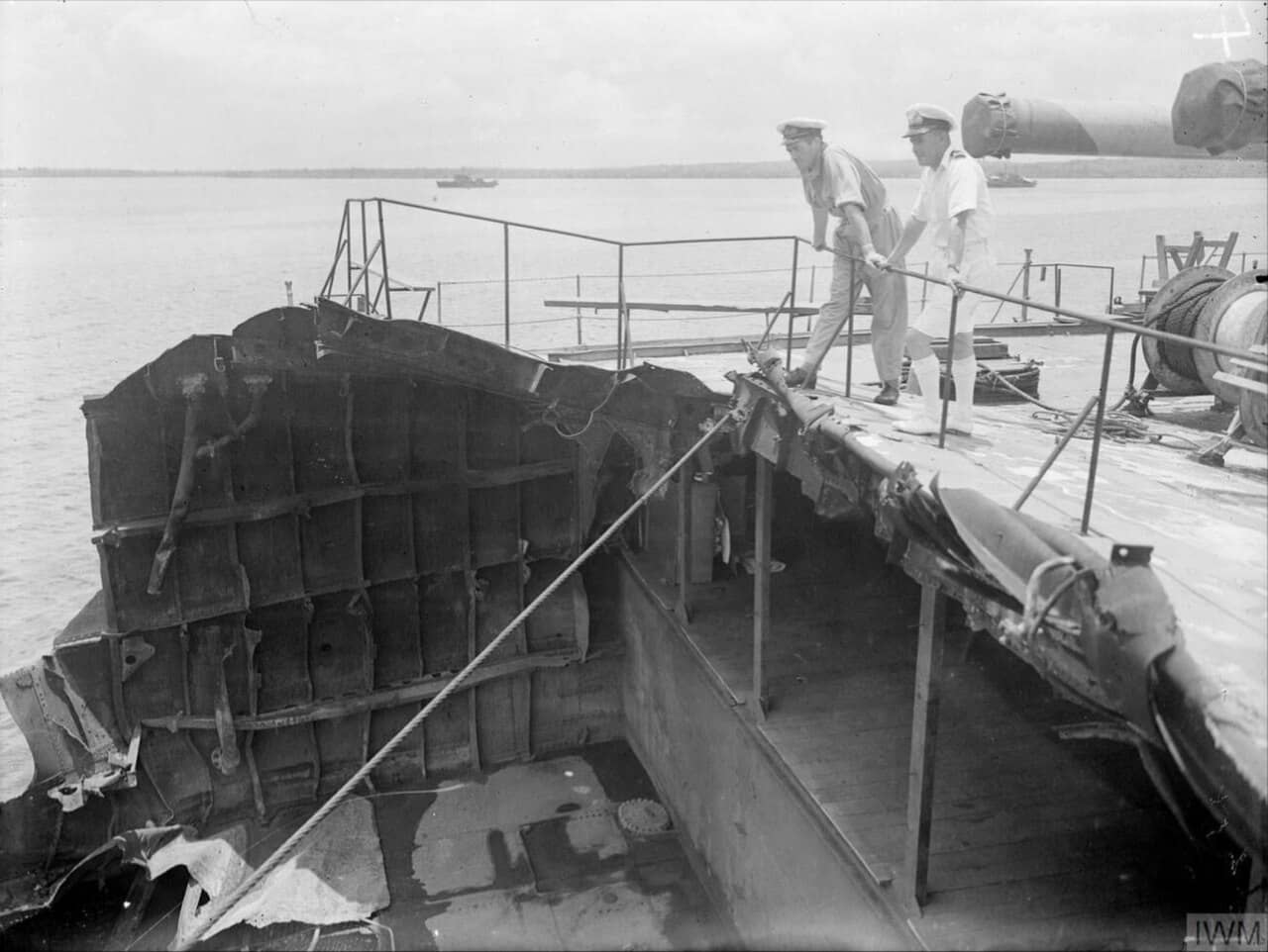 1945年9月25日,两名英国海军军官正在查看妙高号重巡洋舰遭受美军攻击损伤的残存舰艉。