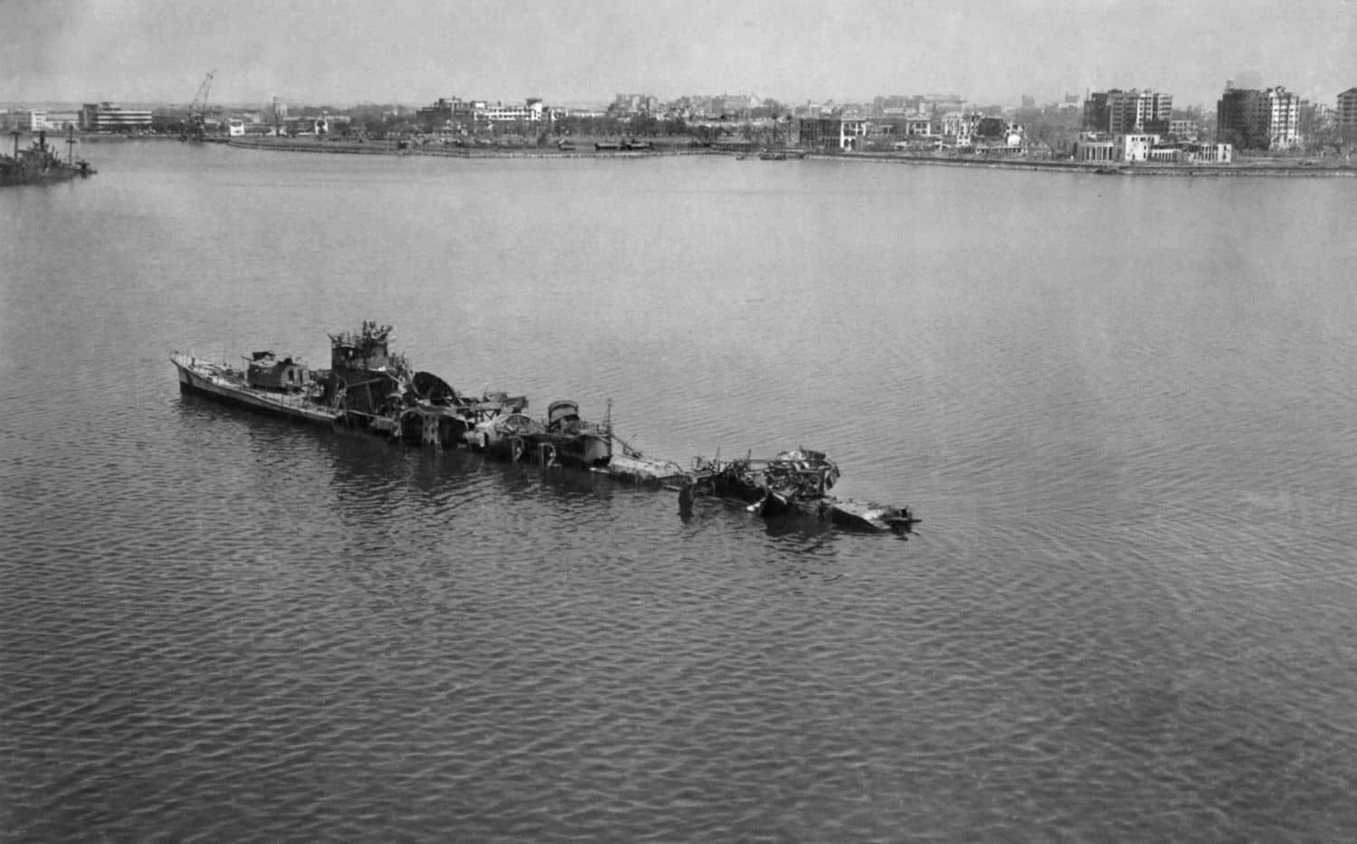 1945年2月拍摄的马尼拉湾浅水中的冲波号驱逐舰残骸。冲波号1944年11月13日随护航编队停泊马尼拉湾时遭美军岸基飞机空袭沉没，与同日战沉的秋霜号同归于尽。