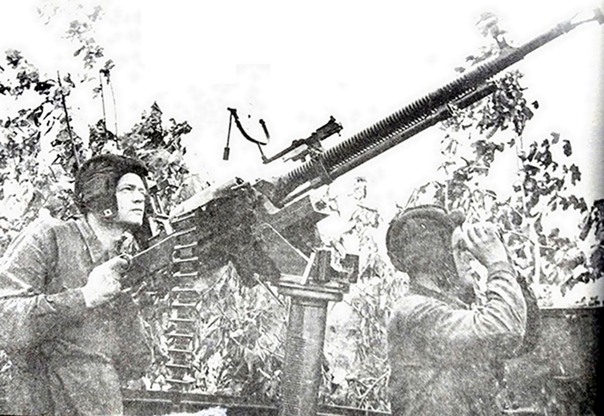 二战东线苏联战场,一列经过伪装的苏军装甲列车上,一挺DShK 1938式重机枪正在对空警戒,一名机枪班战士用望远镜观察天空。