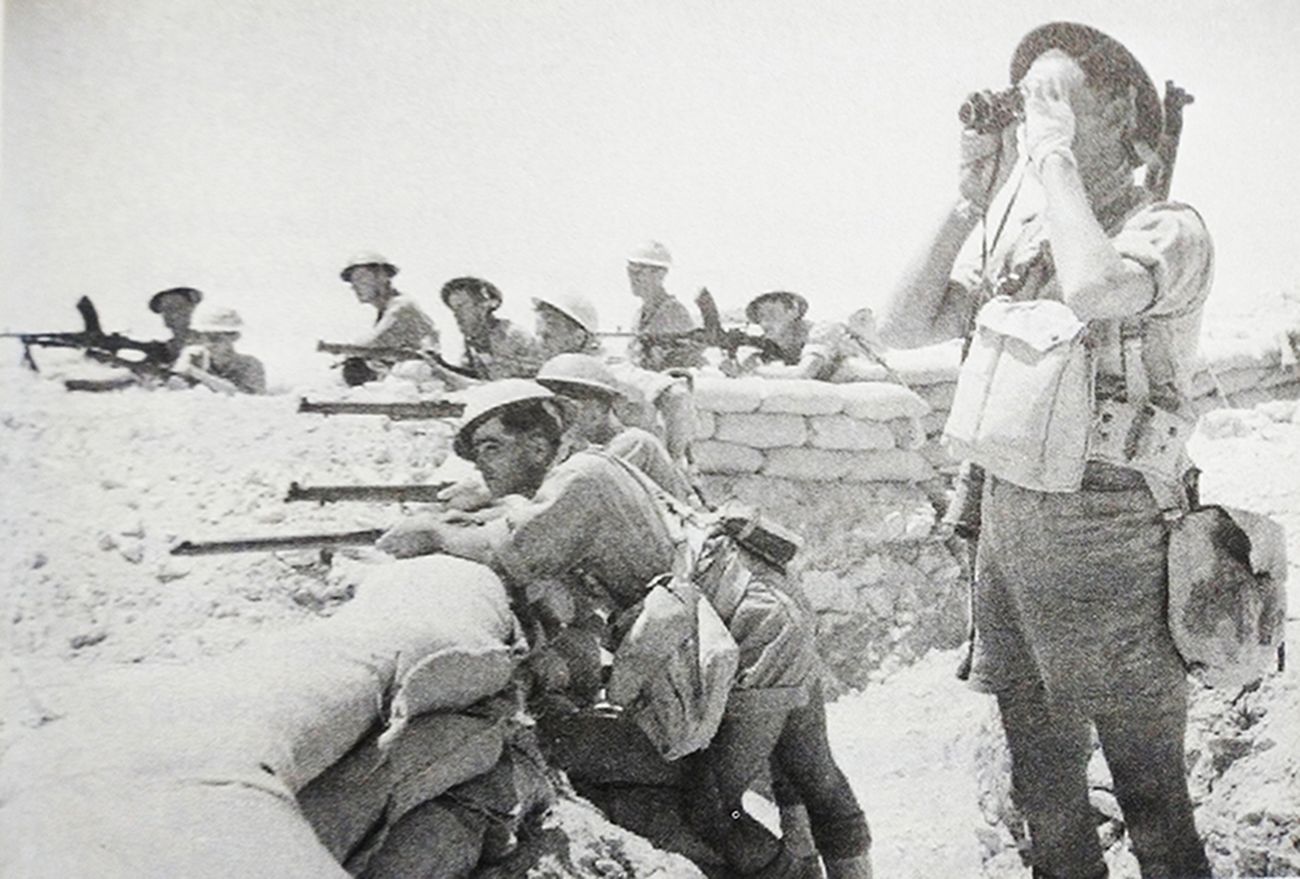 1942年7月，「阿拉曼战役」期间，北非战场埃及阿拉曼地区，装备「李-恩菲尔德」NO.1 MKⅢ型步枪与布伦轻机枪的英军士兵正在阵地中严阵以待。