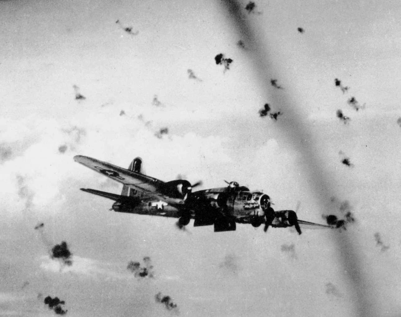 1944年,一架美国陆军航空队B-17G「飞行堡垒」在德国上空穿越密集的高射炮火。美军第8航空队自1942年起对德国实施昼间精确轰炸,B-17编队长期暴露在德军高射炮与战斗机火力之下,凭借坚固机体与密集自卫火力坚持完成任务。