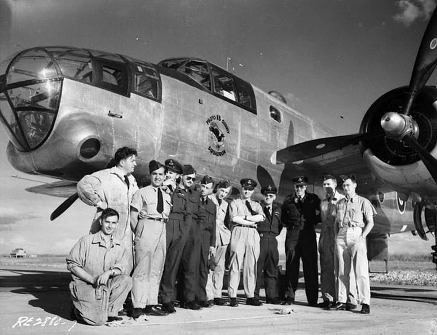 加拿大皇家空军第13图片侦察/测绘中队(No. 13 Photo Survey Squadron, RCAF)的F-10「米切尔」照相侦察机与该机机组人员及维护人员的合影。注意其驾驶舱左侧下方印有该中队的队徽图案。