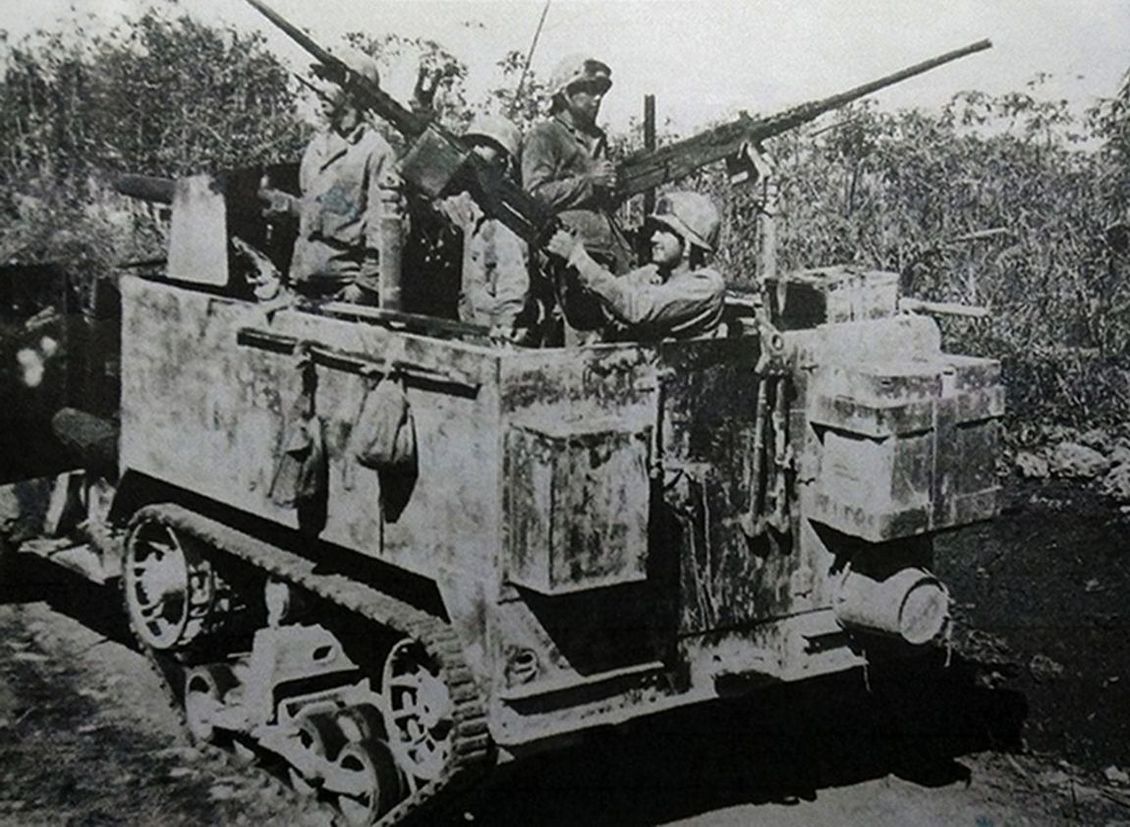 1944年6月,「塞班岛战役」期间,太平洋战场塞班岛,美国海军陆战队第4特种连一辆安装了2挺M2重机枪的半履带装甲车正以战斗姿态在丛林中行进。