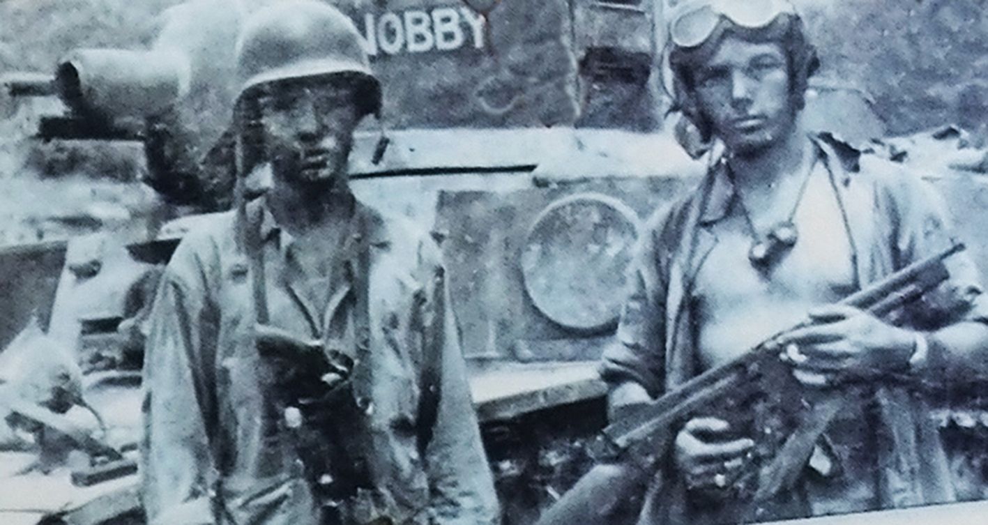 1944年7月,太平洋战场塞班岛,美军一辆喷火坦克的两名乘员,其中一名士兵在并不配套的枪套中插有一支M1917转轮手枪。