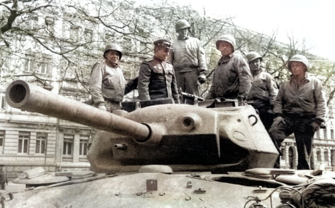 1945年德国,一位苏军军官正在M24轻型坦克上与美军交流。